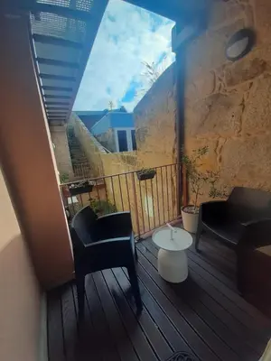 a balcony with chairs and a table and a window at ORM - Almada Balcony Apartment in Porto