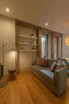 a living room with a couch and a window at ORM - Almada Balcony Apartment in Porto