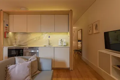a living room with a couch and a kitchen at ORM - Almada Balcony Apartment in Porto
