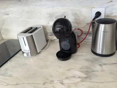 a black blender sitting on a counter next to a toaster at Great&Cosy São Bento in Porto