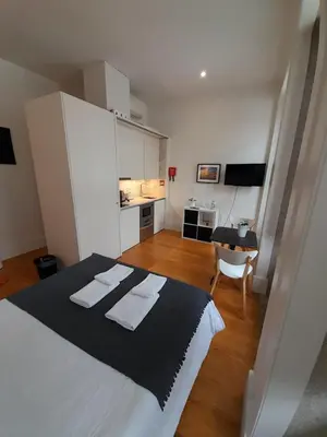 a bedroom with a bed with two towels on it at Great&Cosy São Bento in Porto