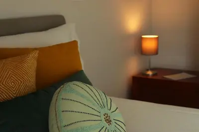 a bedroom with a bed with a pillow and a lamp at Villa Invicta II in Porto