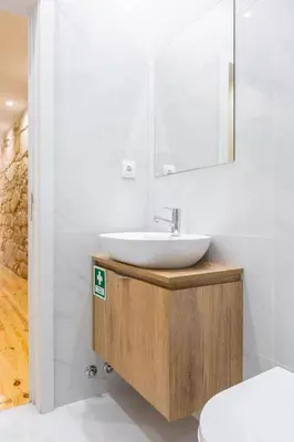 a bathroom with a sink and a mirror at ORM Carregal Apartment in Porto