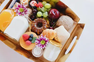 a box filled with different types of bread and fruit at ORM Carregal Apartment in Porto