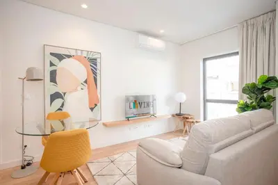 a living room with a couch and a glass table at Liiiving in Porto - City Design Apartments in Porto
