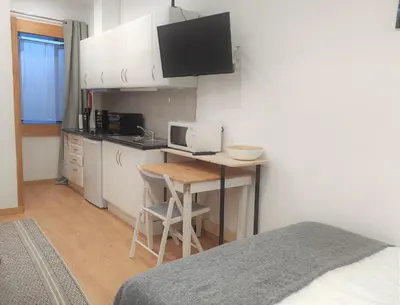 a small kitchen with a desk with a computer on it at Porto Downtown Taipas in Porto