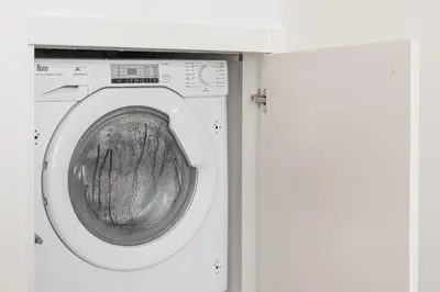 a white washing machine in a white room at GuestReady - Port Studio 2 in Vila Nova de Gaia
