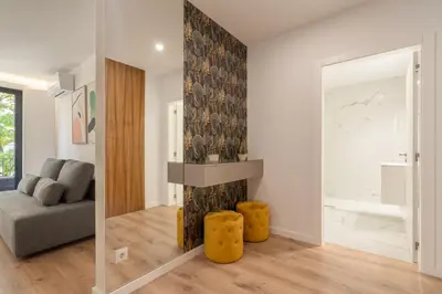 a living room with a fireplace and a couch at Host Wise - Bright & Contemporary Flat - Ace Location in Porto