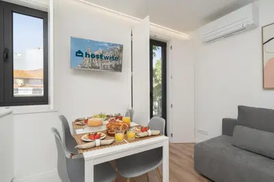 a white living room with a table with food on it at Host Wise - Bright & Contemporary Flat - Ace Location in Porto