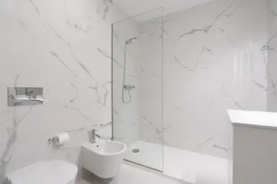 a white bathroom with a shower and a sink at Host Wise - Bright & Contemporary Flat - Ace Location in Porto