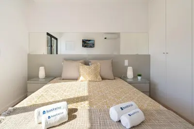a bedroom with a bed with two pillows on it at Host Wise - Bright & Contemporary Flat - Ace Location in Porto