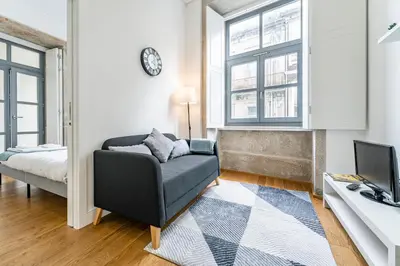 a living room with a couch and a desk at Nomad's Formosa - Apartments Porto in Porto