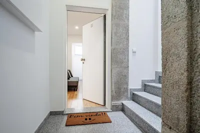 a door leading to a hallway with a welcome mat at Nomad's Formosa - Apartments Porto in Porto