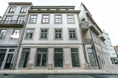 a large white building on a city street at Nomad's Formosa - Apartments Porto in Porto