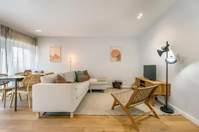 a living room with a white couch and a table at Nomad's Sunny Firmeza - 2BED Porto in Porto