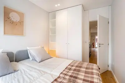 a bedroom with a white bed with a plaid blanket at Nomad's Sunny Firmeza - 2BED Porto in Porto