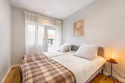 a bedroom with a large bed with a window at Nomad's Sunny Firmeza - 2BED Porto in Porto