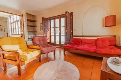 a living room with a red couch and chairs at Ribeira Cozy Apartment in Porto