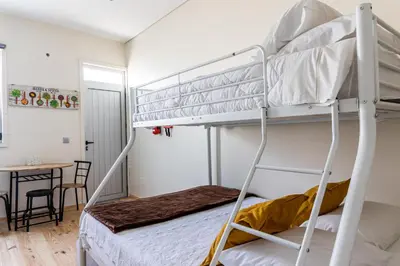 a bedroom with two bunk beds and a table at House on a rustic Island At Campanha Trainstation in Porto