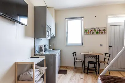 a small kitchen with a sink and a table at House on a rustic Island At Campanha Trainstation in Porto