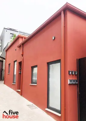 a red house with windows on the side of it at Five House 14B in Porto