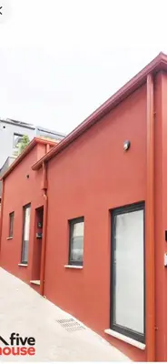a red building with windows on the side of it at Five House 14B in Porto