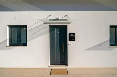 a door on the side of a white building at WHome Riverside View Premium Apartment w/ AC & Terrace in Porto