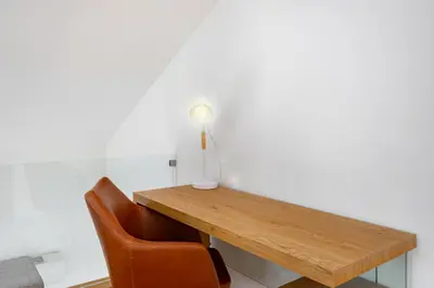 a wooden table with two chairs and a lamp on it at WHome Riverside View Premium Apartment w/ AC & Terrace in Porto