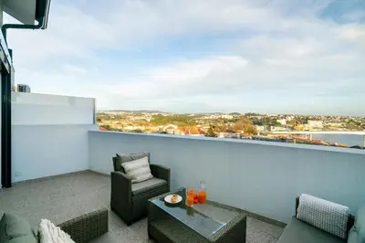 a balcony with a view of a city at WHome Riverside View Premium Apartment w/ AC & Terrace in Porto
