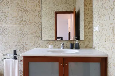 a bathroom with a sink and a mirror at Boavista Studio 99 & Garage in Porto