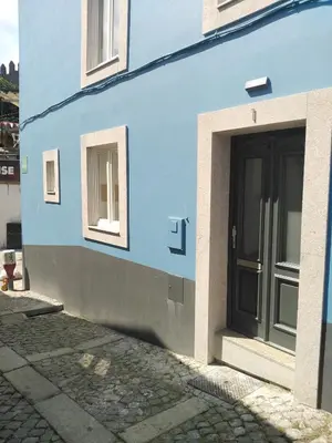 a blue building with a door and windows at Dos Guindais - Turismo Urbano, Miradouro in Porto