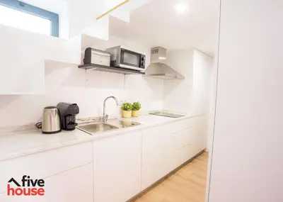 a white kitchen with a sink and a microwave at Five House 14A in Porto