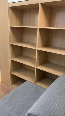a closet with wooden shelves next to a bed at Five House 14A in Porto