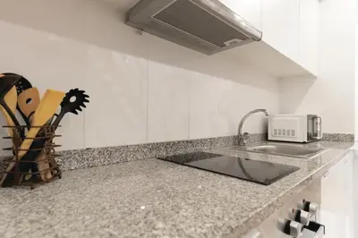 a kitchen counter with a sink and a microwave at Douro by your side with Pool in Vila Nova de Gaia