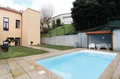 a swimming pool in a yard next to a building at Douro by your side with Pool in Vila Nova de Gaia