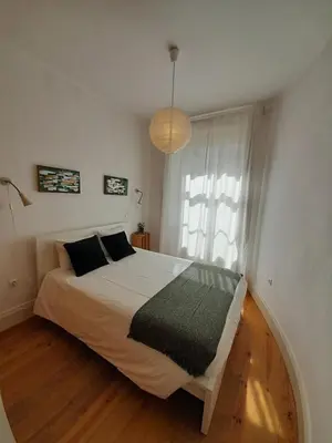 a bedroom with a bed and a large window at Comfortable Central 2 Bedrooms Apartments by Great&Cosy in Porto