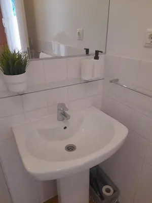 a white bathroom with a sink and a mirror at Comfortable Central 2 Bedrooms Apartments by Great&Cosy in Porto