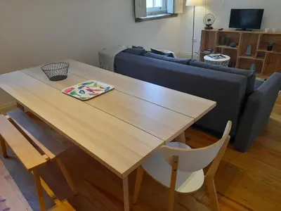 a living room with a wooden table and a couch at Comfortable Central 2 Bedrooms Apartments by Great&Cosy in Porto