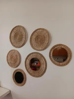 a wall with four wicker mirrors on a wall at Comfortable Central 2 Bedrooms Apartments by Great&Cosy in Porto