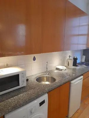 a kitchen with a sink and a microwave at Comfortable Central 2 Bedrooms Apartments by Great&Cosy in Porto