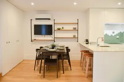 a kitchen and dining room with a table and chairs at Lindo apartamento 2 quartos com pátio - Batalha - APT C in Porto