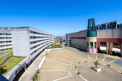 a view of a building with a basketball court in front at Estúdio Encantador com vistas para o Douro Gaia in Vila Nova de Gaia