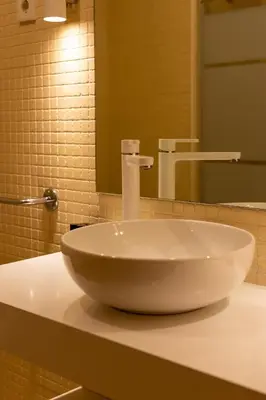 a white sink in a bathroom with a mirror at Estúdio Encantador com vistas para o Douro Gaia in Vila Nova de Gaia