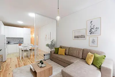 a living room with a couch and a table at Lóios 1BR Flat Downtown by LovelyStay in Porto