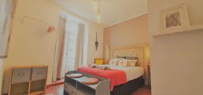 a bedroom with a bed with a red blanket at Clérigos City Heart Flat in Porto