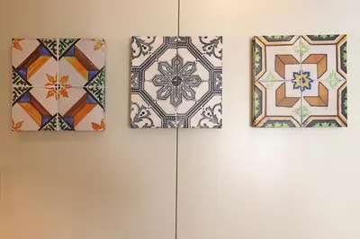 three pieces of art hanging on a wall at FLH Sá da Bandeira Modern Apartment in Porto