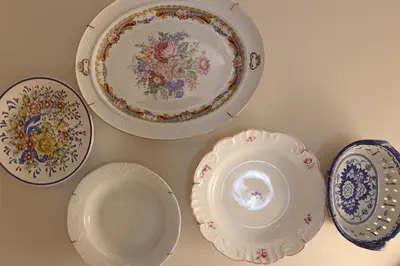 a group of plates and bowls on a wall at FLH Porto Ribeira Typical Studio in Porto