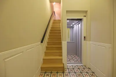 a hallway with a staircase with wooden floors and a door at FLH Porto Ribeira Typical Studio in Porto