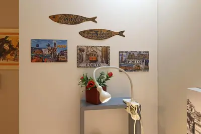 a room with a lamp and pictures on the wall at FLH Porto Ribeira Typical Studio in Porto