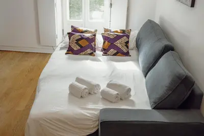a large couch with towels on it in a living room at OPORTO GUEST Lotte House in Porto